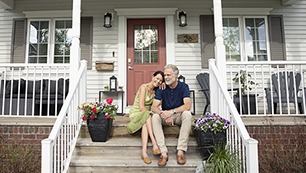 Affectionate senior couple relaxing on front stoop